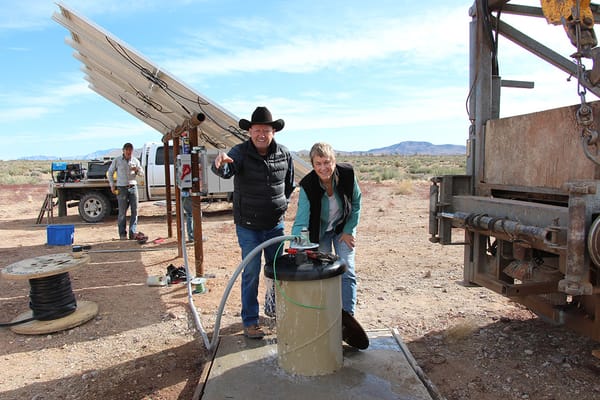 Image: Greg Newby (l) and Teri Knight celebrate the installation of a new solar pumping plant.