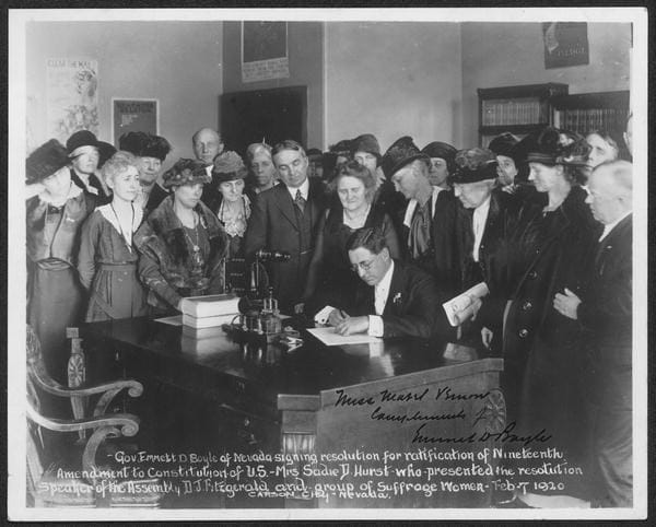 Governor Emmett D. Boyle of Nevada signing resolution for ratification of Nineteenth Amendment to Constitution. Mrs. Sadie D.