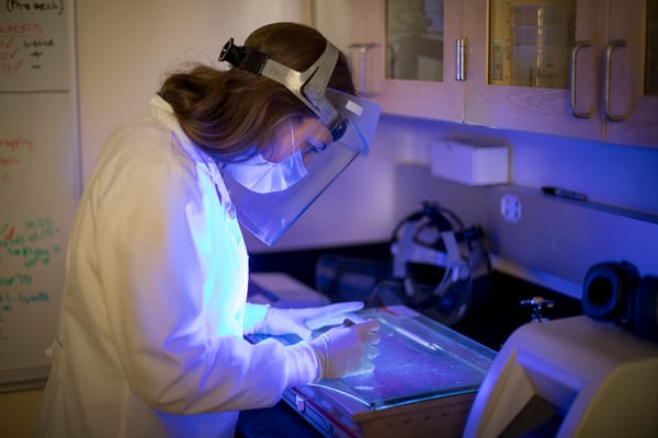 Graduate student Salome Manska analyzes human cells under fluorescent microscope in the Verma Rossetto Lab at the University 