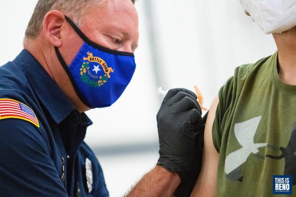 A Reno Fire Department employee administers the COVID-19 vaccine to a Reno resident on April 24, 2021.