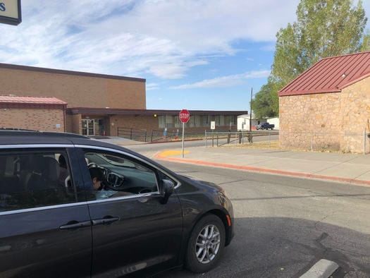A student at Owyhee Consolidated School studies in the parking lot in order to use the building's Wi-Fi signal. (Lynn Manning